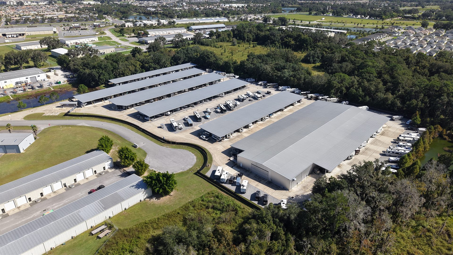 Aerial drone photo of a self storage facility showing its location, road access and surrounding rooftops
